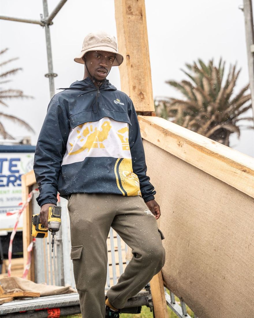 A builder holding a drill on a building site